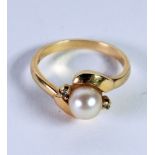 14k GOLD CROSSOVER RING, set with a cultured pearl and two tiny diamonds, approx 3.5gms