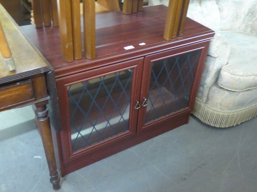A MAHOGANY DWARF CUPBOARD ENCLOSED BY TWO LEAD LIGHT DOORS