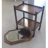 AN OCTAGONAL BEVELLED EDGE WALL MIRROR IN BEADED EDGE OAK FRAME AND AN OAK TWO TIER TEA TROLLEY (2)