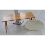 AN OVAL BEVELLED EDGE FRAMELESS WALL MIRROR, A TEAK OBLONG COFFEE TABLE (2)