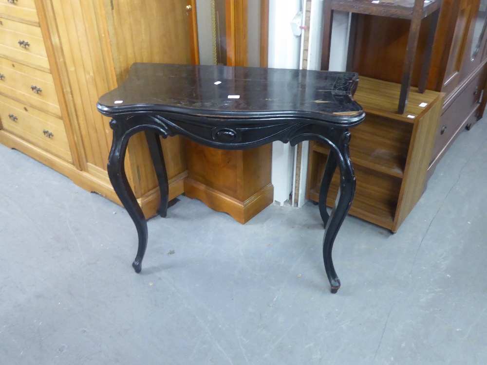 AN EBONISED FOLD-OVER CARD TABLE WITH OUT-SWEPT LEGS (A.F.)