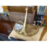 A GILT CONSOL PATTERN WALL BRACKET AND A SMALL GILT FRAMED OVAL WALL MIRROR