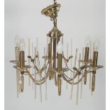 MODERN GILT METAL AND CLEAR GLASS TEN LIGHT ELECTROLIER, of two tier form with scroll arms and
