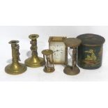 A PAIR OF BRAS PIXIE PATTERN CANDLESTICKS, A CIRCULAR BISCUIT TIN, TWO BRASS SAND TIMERS AND A