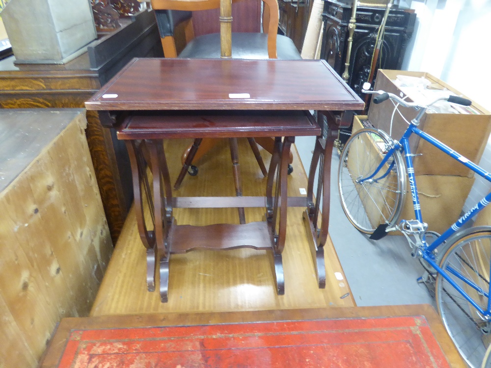 A NEST OF TWO MAHOGANY COFFEE TABLES WITH LYRE SHAPED SUPPORTS