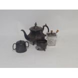 TWO POTTERY HOT WATER BOTTLES, AND THREE PIECES OF E.P. WARES - TEA SET AND A GLASS SUGAR BOWL