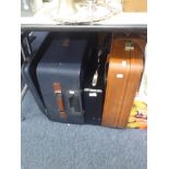 A BLACK LEATHER ATTACHÉ CASE AND TWO LARGE SUITCASES