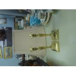 A PAIR OF ANTIQUE BRASS CANDLESTICKS WITH FLUTED TAPERING COLUMNS AND SQUARE BASES (2)