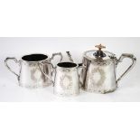 THREE PIECE ELECTROPLATED TEA SET, of oval, tapering form with angular scroll handles, engraved with