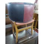 A PIANO STOOL AND A LEATHER COVERED POUFFE