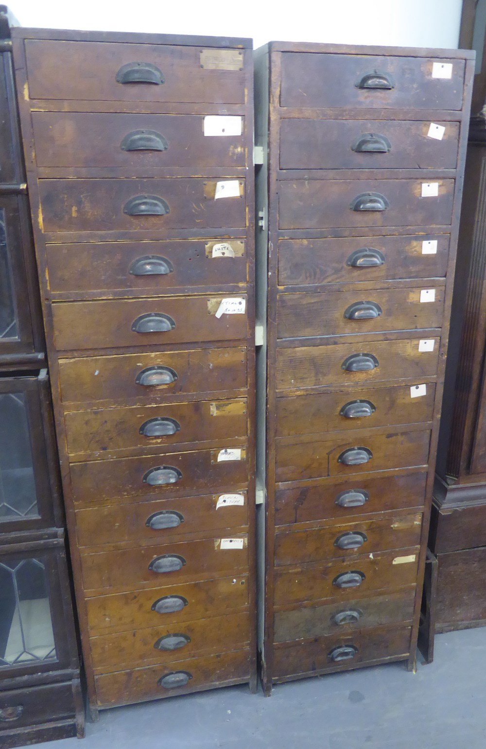 A PAIR OF TALL PINE MULTI-DRAWER FILING CABINETS, EACH 1'6" WIDE, 6' HIGH