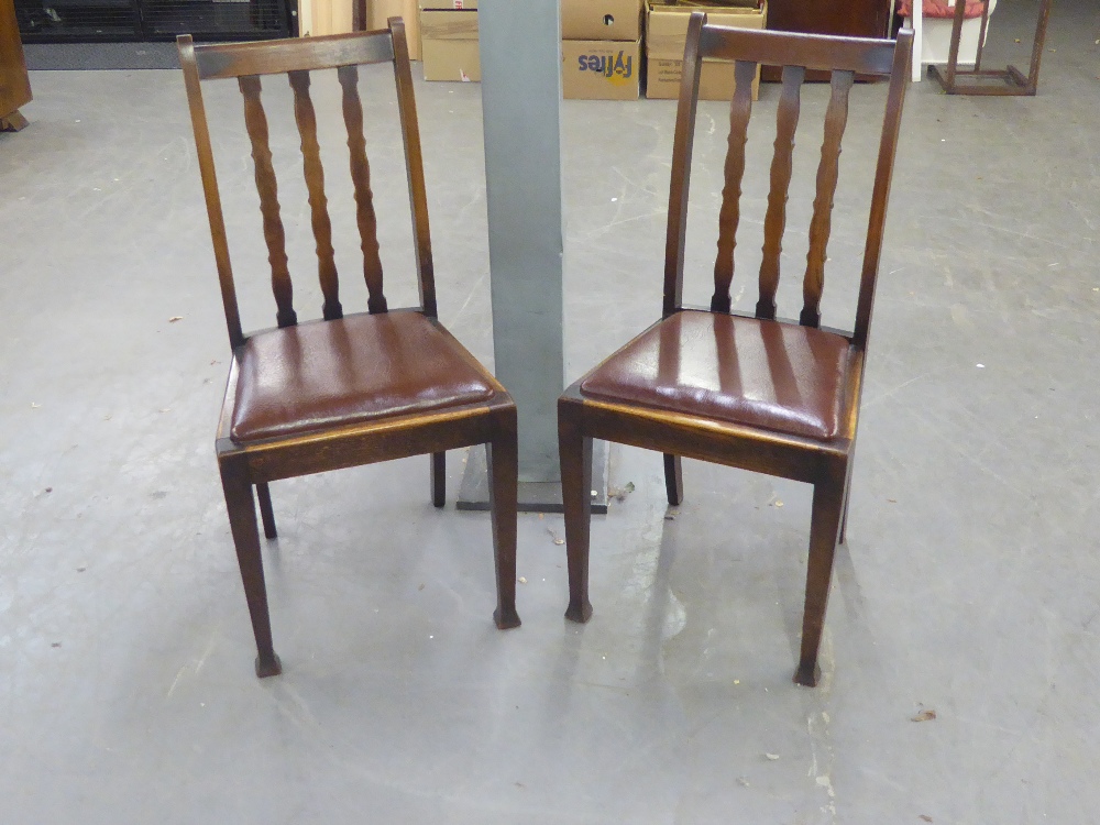 A SET OF FOUR OAK RAIL BACK DINING CHAIRS WITH DROP-IN SEATS
