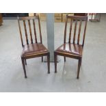 A SET OF FOUR OAK RAIL BACK DINING CHAIRS WITH DROP-IN SEATS