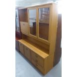 A TEAK EFFECT SIDE CABINET WITH DISPLAY SECTION AND A FALL FRONT SECTION, ON ADVANCED BASE WITH