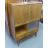 A MODERN TEAK CUPBOARD OVER DISPLAY CABINET WITH SHORT DRAWERS THROUGHOUT