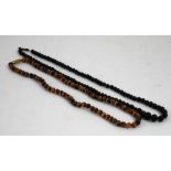 A SINGLE STRAND NECKLACE OF CAT'S EYE ROUND BEADS, 18" long and A BEAD NECKLACE (2)