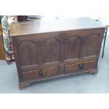 A LARGE 18TH CENTURY OAK DOWER CHEST WITH HINGED LID, FOUR PANEL FRONT, TWO DRAWERS BELOW, ON OGEE