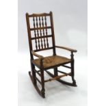 NINETEENTH CENTURY ELM SPINDLE BACK ROCKING CHAIR, of typical form with fifteen turned spindles