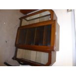 AN ART DECO WALNUT BREAKFRONT BOOKCASE, WITH GLAZED DOOR AND END DISPLAY SECTIONS, EACH WITH A