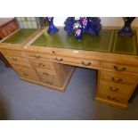 A MODERN PINE TWIN PEDESTAL DESK WITH THREE DRAWERS TO EACH PEDESTAL BELOW THREE NARROW DRAWERS WITH