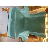 A PARKER KNOLL ARMCHAIR, UPHOLSTERED IN GREEN VELVET ON CABRIOLE LEGS