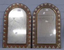 A PAIR OF MILESTONE SHAPED WALL MIRRORS in decorated copper, brass and white metal frames, 19" high,