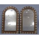 A PAIR OF MILESTONE SHAPED WALL MIRRORS in decorated copper, brass and white metal frames, 19" high,