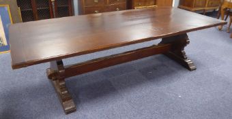 LARGE TWENTIETH CENTURY DARK STAINED OAK REFECTORY TABLE, with thick plank top raised on shaped