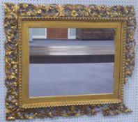 NINETEENTH CENTURY CARVED GILT WOOD LARGE WALL MIRROR, the later oblong plate in a picture type