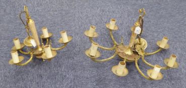 A GILT BRASS EIGHT LIGHT ELECTROLIER, with 'C' scroll branches, candle pattern sconces and onyx