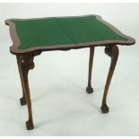 GEORGE II STYLE CROSSBANDED WALNUTWOOD CARD TABLE, the fold over shaped oblong top with green