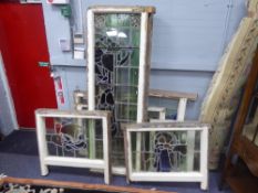 A SUITE OF TWELVE CIRCA 1900 STAINED AND PAINTED LEADED GLASS WINDOWS, in the Historical Revival