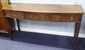 GEORGE III MAHOGANY BOW FRONTED SIDE TABLE with three frieze drawers with cockbeaded borders,