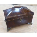 GEORGE III MAHOGANY TEA CADDY, sarcophagus shaped on three bacchanalian embossed brass tab feet, 8