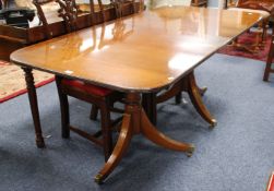 REGENCY STYLE MAHOGANY AND BRASS INLAID DOUBLE PEDESTAL DINING TABLE with cross banded borders,