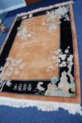 TWENTIETH CENTURY WASHED CHINESE CARPET, with gold ground and plain black borders, the design of