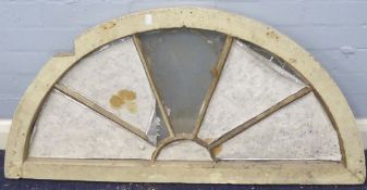 ANTIQUE FANLIGHT with white painted wood half-moon frame and partly overlaid radiating glazing bars,