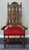 19th CENTURY CARVED OAK CHAIRMAN'S CHAIR of Carolean style, the upholstered seat covered in wine