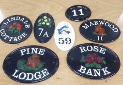 THREE COLD PAINTED EMBOSSED CAST IRON HOUSE NAME PLATES and THREE SMALLER, with house numbers