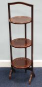 EARLY 20th CENTURY LINE INLAID MAHOGANY CIRCULAR THREE TIER FOLDING CAKE STAND on cheval feet