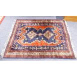 EASTERN RUG with triple diamond pattern, pole medallion on a dark blue field with irregular red,