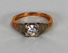 18ct GOLD AND PLATINUM RING, with a round brilliant cut solitaire diamond in a square setting with