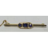 EDWARDIAN 9ct GOLD BAR BROOCH, the pointed oblong centre set with three round sapphires and two