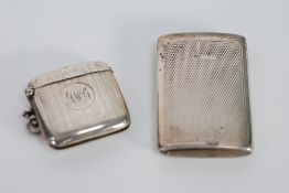 TWO ENGINE TURNED SILVER VESTA CASES, one of typical form, initialled Chester 1915, the other of