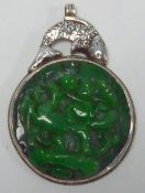 ANTIQUE CHINESE SILVER AND JADE LARGE CIRCULAR PENDANT, the circular emerald green jade panel, 3"