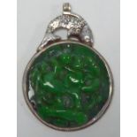 ANTIQUE CHINESE SILVER AND JADE LARGE CIRCULAR PENDANT, the circular emerald green jade panel, 3"