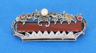 SILVER AND MARCASITE BROOCH OF CORONET SHAPE framing an oblong cornelian panel, the floral top set