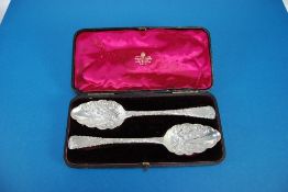 PAIR OF GEORGE III SILVER SERVING SPOONS, the bowls chased and repousse with scrolls and having