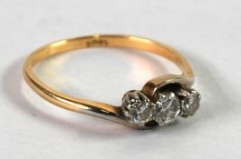 18ct GOLD CROSS OVER RING, set with three broad brilliant cut diamonds, approx .40ct in total,