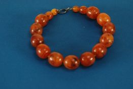 A PROBABLY INTER-WAR YEARS POSSIBLY RE-CONSTITUTED AMBER GRADUATED BEAD NECKLACE, each bead